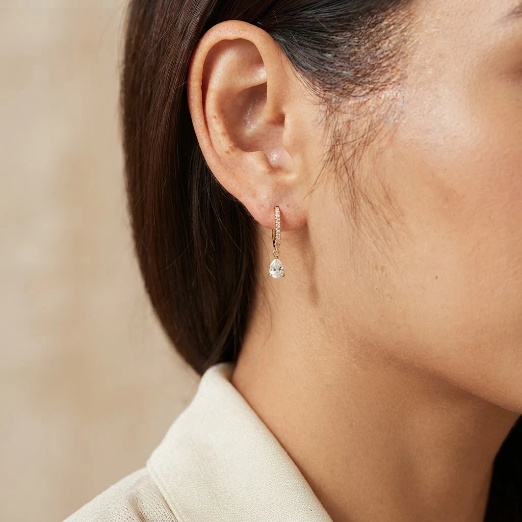 Birthstone Glow Earrings 18K — worn on model in natural light