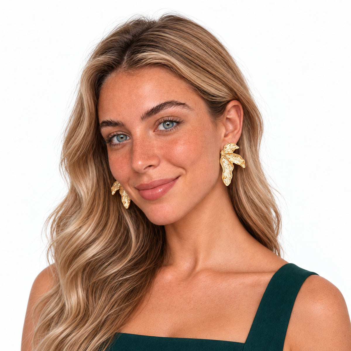 Model wearing gold Fallen Leaf Earrings in a product-focused portrait